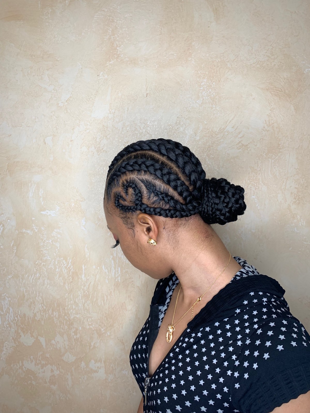 Braided bun updo with swirl cornrow detail