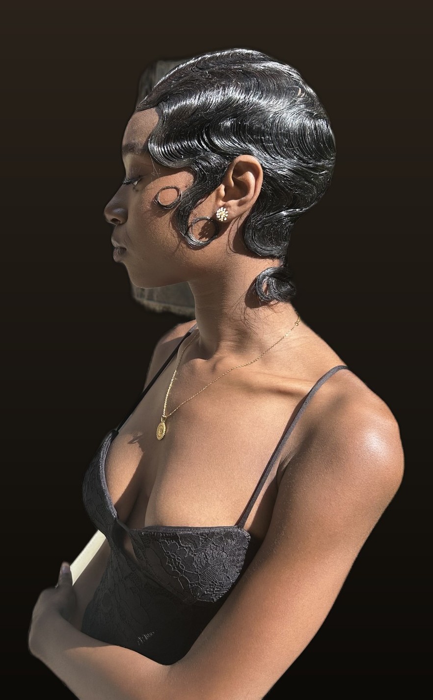 High bun updo with curled tendrils